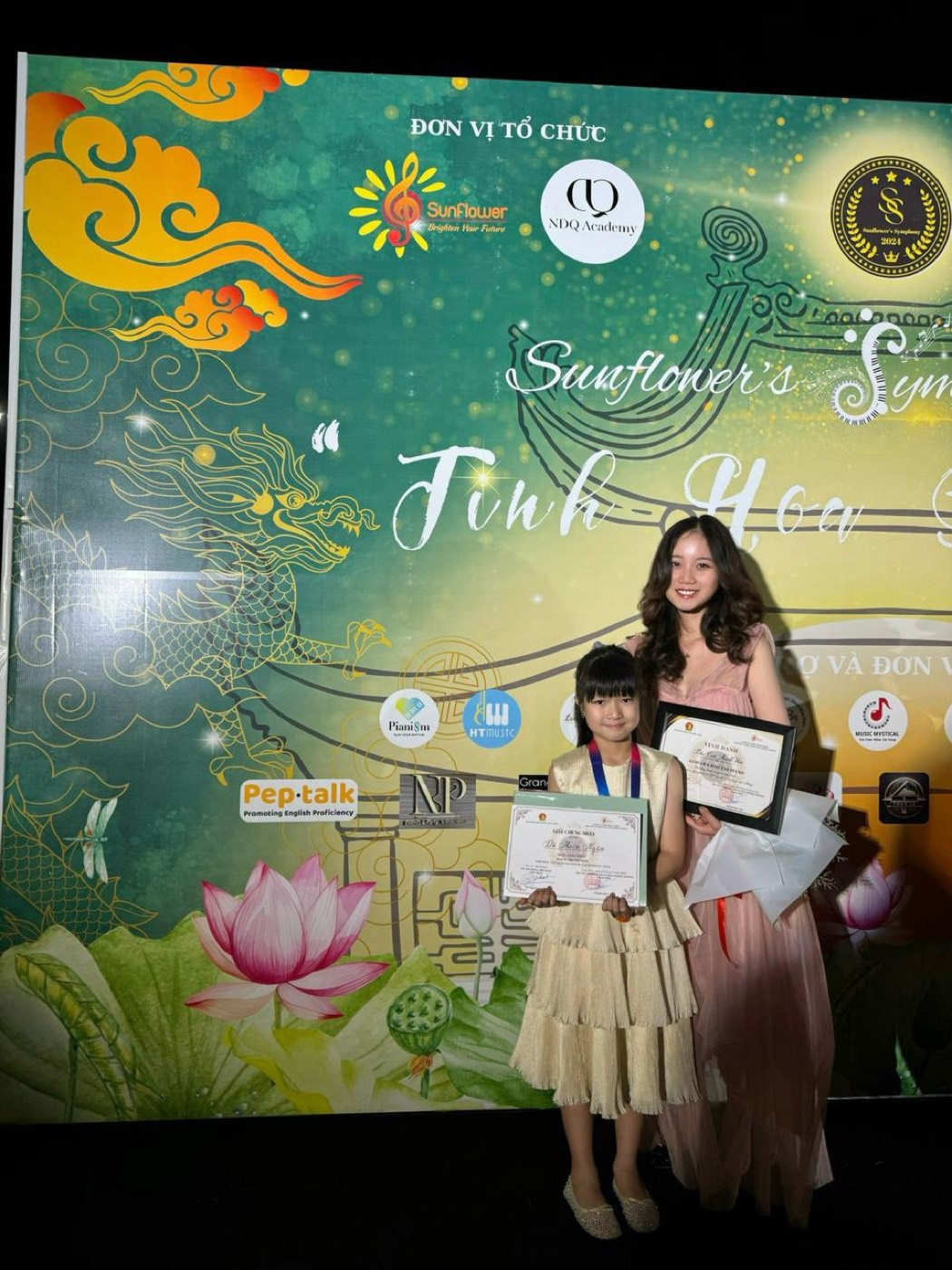 Ms Van with her student at the Sunflower's Symphony 2024 award ceremony, holding their certificates